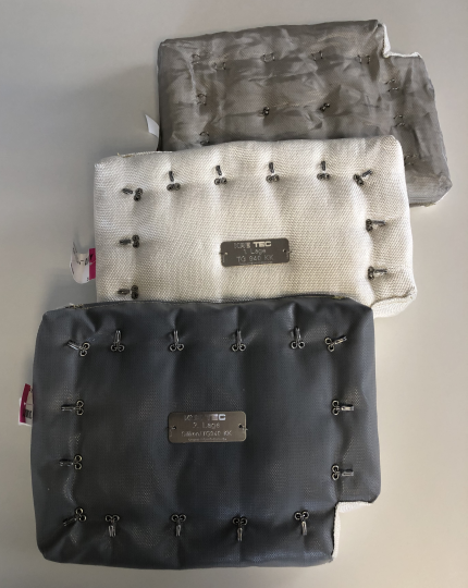 Three different rectangular insulation pads for shipbuilding, equipped with metallic lace hooks