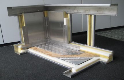 Cross-section of an insulated wall and floor structure for shipbuilding, showing the different layers of metal profiles, insulation material, and floor coverings