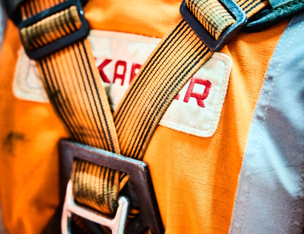 Detailaufnahme eines zertifizierten Auffanggurts für Höhenarbeiter mit deutlichem Fokus auf die Sicherheitsschnallen und die robuste Materialstruktur